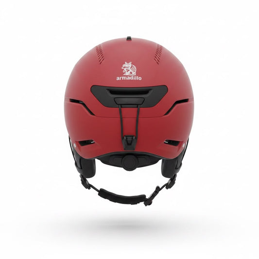 A matte red ski helmet with black chin strap and vents, featuring the 'armadillo' brand logo on the front, shown against a plain white background.